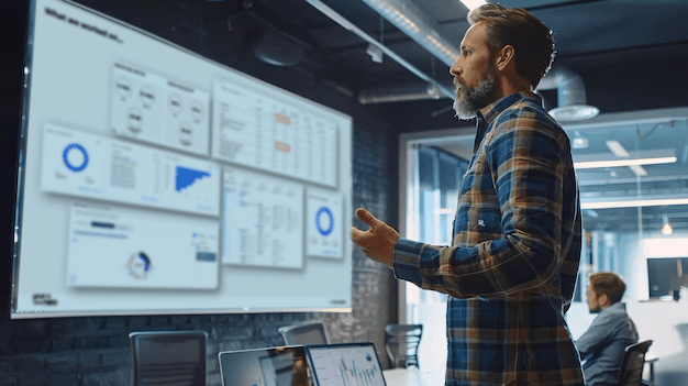 Ein Mann blickt auf Datenauswertungen auf mehreren Bildschirmen.